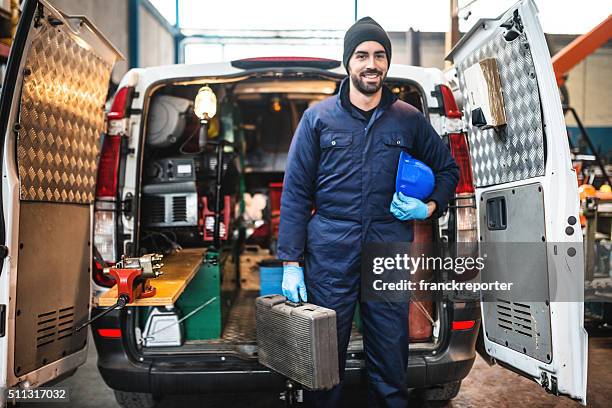 mechanic technician on a garage - gereedschap stockfoto's en -beelden