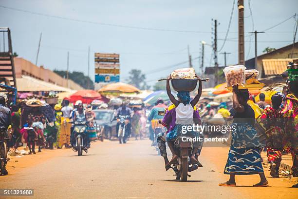 west african market scene. - carrying bike stock pictures, royalty-free photos & images