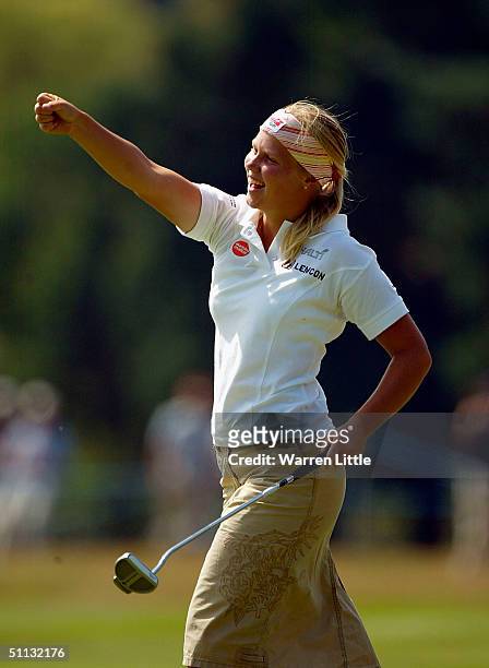 Minea Blomqvist of Finland celebrates after scoring a birdie on the 18th hole to claim the course and championship record during the third round of...