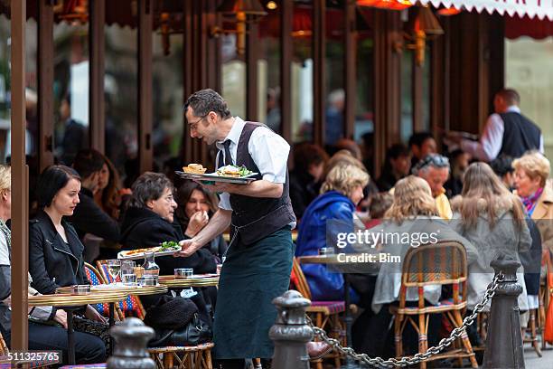 waiter serving food, cafe le bonaparte, saint germain, paris, france - restaurant paris stock pictures, royalty-free photos & images