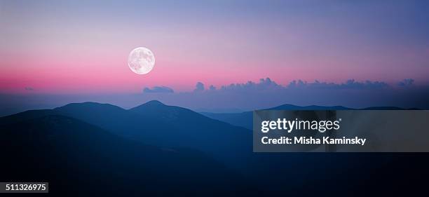 fool moon rising over the mountain range - moody sky moon night stock pictures, royalty-free photos & images