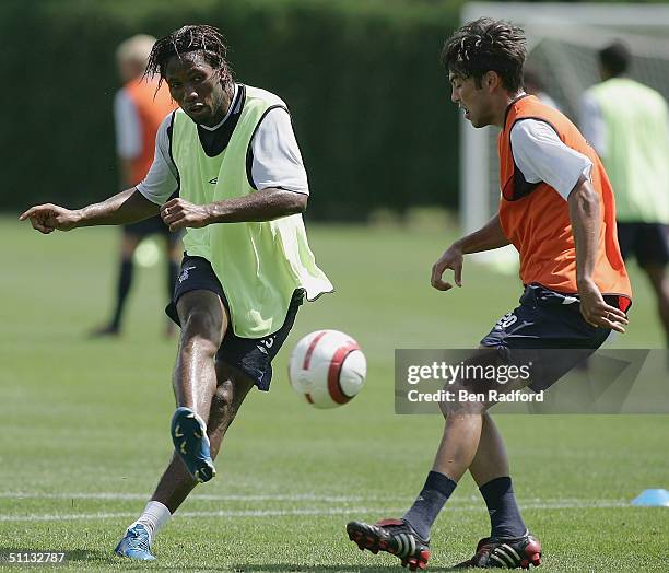 Didier Drogba of Chelsea shoots as Paulo Ferreira defends during Chelsea pre-season training at The Novacare Centre on July 31, 2004 in Philadelphia,...