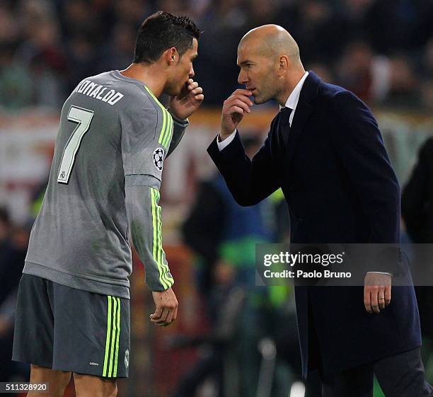 Cristiano Ronaldo of Real Madrid CF speaks with his head coach Zinedine Zidane during the UEFA Champions League round of 16 first leg match between...