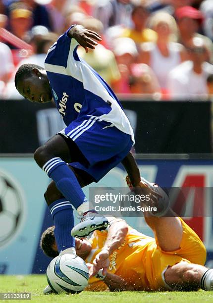 Freddy Adu of the East All-Stars controls the ball as Jeff Agoos of the West All-Stars defends during the Sierra Mist MLS All-Star Game at RFK...