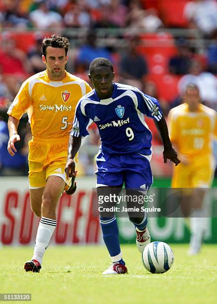 Freddy Adu of the East All-Stars controls the ball as Kerry Zavagnin of the West All-Stars defends during the Sierra Mist MLS All-Star Game at RFK...