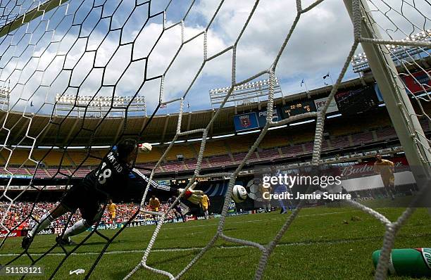 Amando Guevara of the East All-Stars scores against goalkeeper Pat Onstad of the West All-Stars on a penalty kick during the Sierra Mist MLS All-Star...