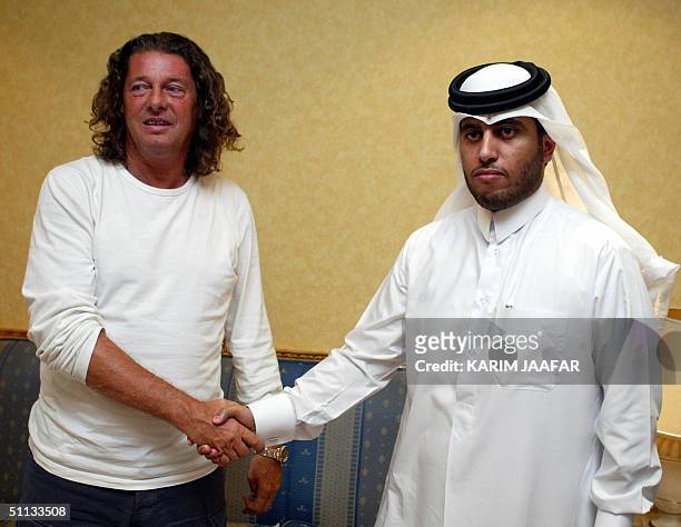 France's Bruno Metsu, former coach of UAE club Al-Ain, is received by Sheikh Thani bin Thamer al-Thani in Doha airport after signing to coach Qatar's...