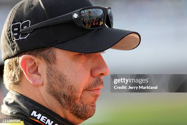 Matt Crafton, driver of the Menards/Slim Jim Toyota, stands on the grid during qualifying for the NASCAR Camping World Truck Series NextEra Energy...