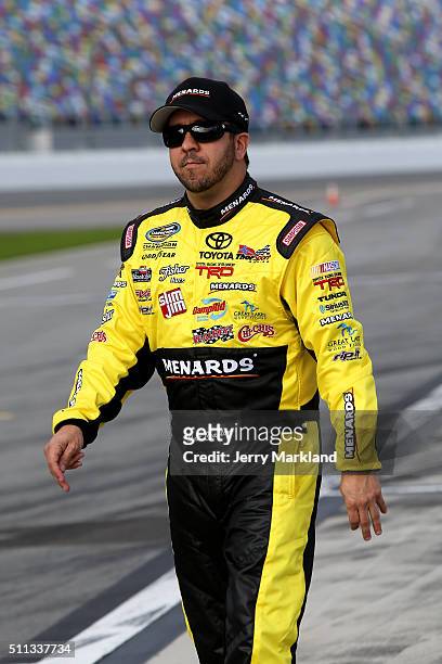 Matt Crafton, driver of the Menards/Slim Jim Toyota, stands on the grid during qualifying for the NASCAR Camping World Truck Series NextEra Energy...