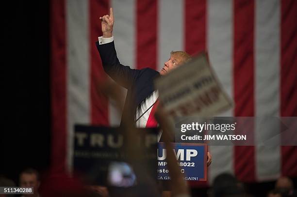 Republican presidential candidate Donald Trump points to the roof during a campaign rally in North Charleston, South Carolina, February 19, 2016. /...