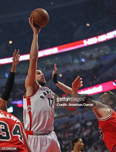 Jonas Valanciunas of the Toronto Raptors shoots over Pau Gasol of the Chicago Bulls at the United Center on February 19, 2016 in Chicago, Illinois....