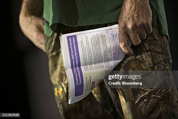 Television personality Phil Robertson holds a paper discussing sexually transmitted diseases as he speaks ahead of Senator Ted Cruz, a Republican...