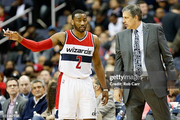 John Wall of the Washington Wizards talks with head coach Randy Wittman during the second half of the Wizards 98-86 win over the Detroit Pistons at...