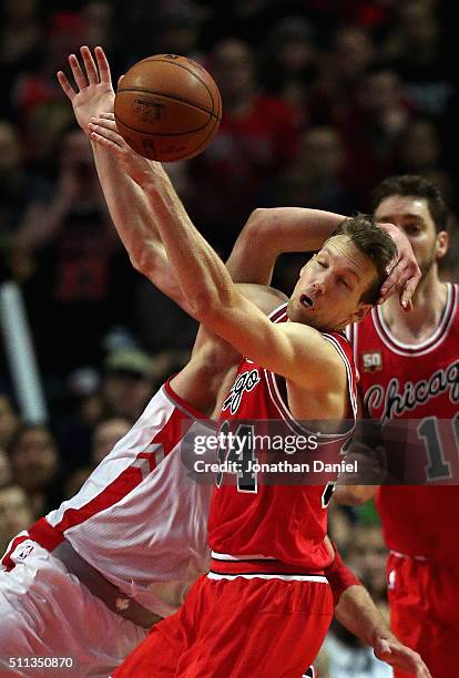 Mike Dunleavy of the Chicago Bulls is hit by Jonas Valanciunas of the Toronto Raptors at the United Center on February 19, 2016 in Chicago, Illinois....