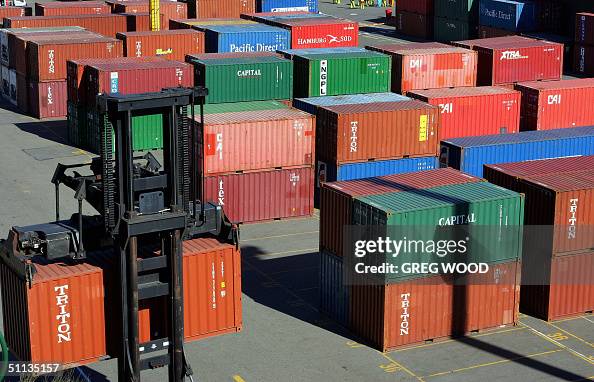 A fork lift (below-L) moves export shipp A fork lift (below-L) moves export shipp
