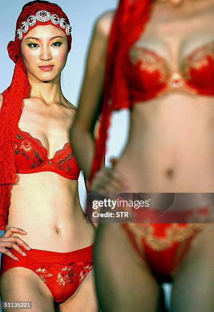 Chinese models show off a range of the latest undergarments launched by a local fashion house in Beijing 02 August 2004. The undergarment industry in...