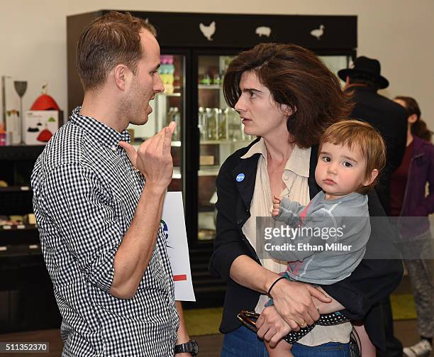 Johnny Misheff of New York talks with actress Gaby Hoffmann, holding her daughter Rosemary Dapkins, as she campaigns for Democratic presidential...