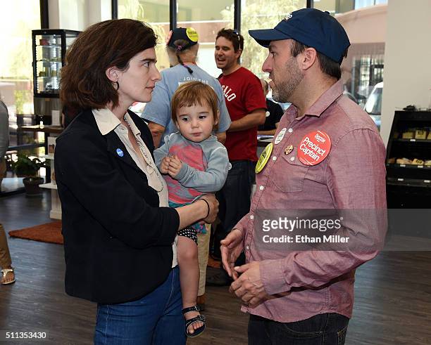 Actress Gaby Hoffmann holds her daughter Rosemary Dapkins as she talks with precinct captain Joe Sacco of Nevada while campaigning for Democratic...