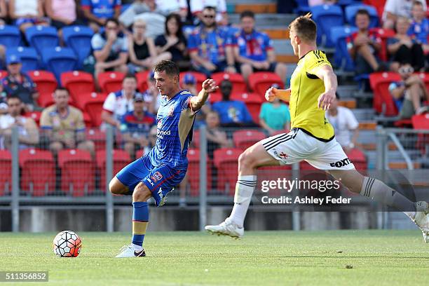Enver Alivodic of the Jets is tackled by the Phoenix defence during the round 20 A-League match between the Newcastle Jets and Wellington Phoenix at...