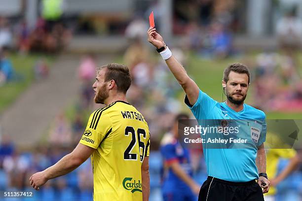 Referee Chris Beath issues a red card to Hamish Watson of the Phoenix during the round 20 A-League match between the Newcastle Jets and Wellington...