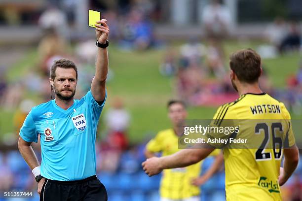 Referee Chris Beath issues a second yellow card to Hamish Watson of the Phoenix during the round 20 A-League match between the Newcastle Jets and...