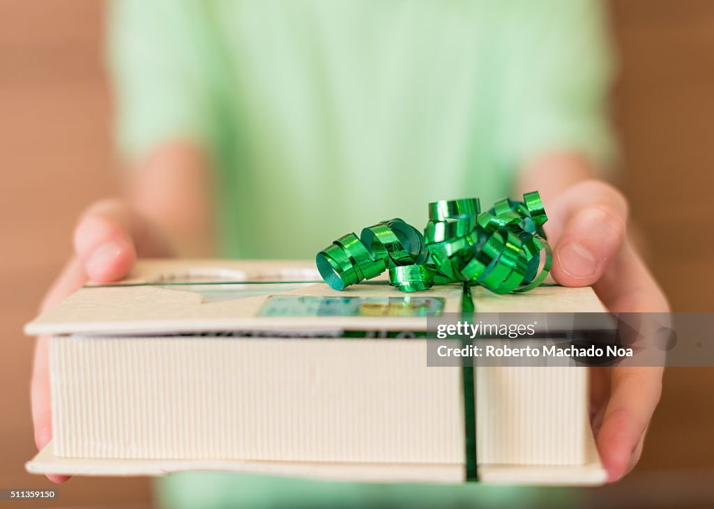 Close-up of male hands holding a Christmas present or new...