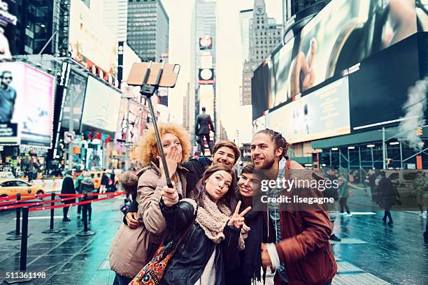 group of friends making selfie - times square stock pictures, royalty-free photos & images