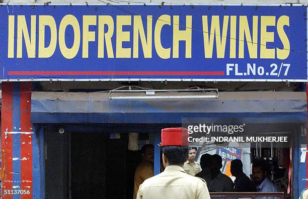 In this picture taken, 28 July 2004, an Indian policeman stands in front of a liquor shop at Mahe in the Indian Union Territory of Pondicherry. As...