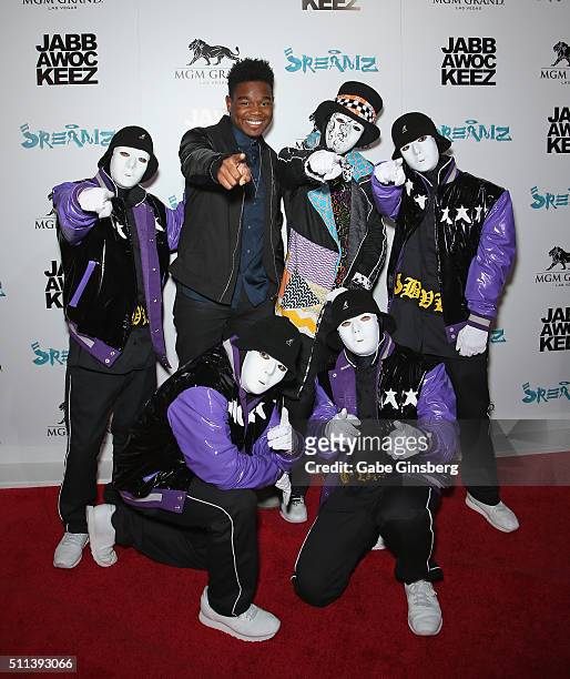 Actor Dexter Darden poses with members of the Jabbawockeez dance crew during the grand opening of the Jabbawockeez dance crew's show "JREAMZ" at MGM...