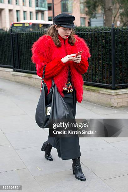 Red Thread magazine editor-in-chief Beth Buxton wears a vintage coat, Gayeon Lee culottes and top, Zara boots and Mulberry bag on day 1 during London...