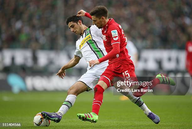 Lars Stindl of Borussia Moenchengladbach and Filip Mladenovic of Koeln compete for the ball during the Bundesliga match between Borussia...