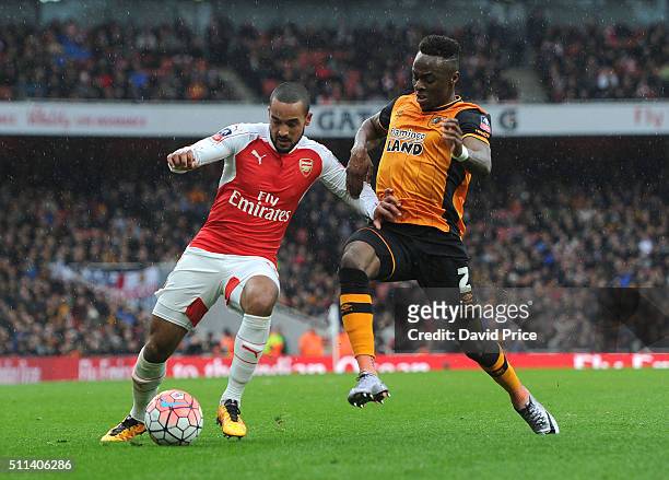 Theo Walcott of Arsenal holds off Moses Odubajo of Hull during the match between Arsenal and Hull City in the FA Cup 5th Round at Emirates Stadium on...