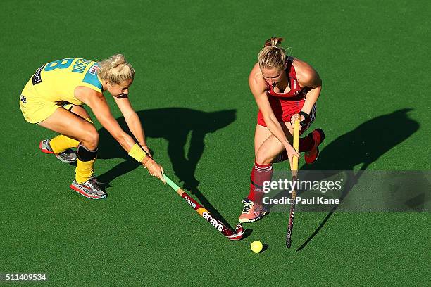 Ashleigh Nelson of Australia tackles Susie Gilbert of Great Britain during the International Test match between the Australian Hockeyroos and Great...