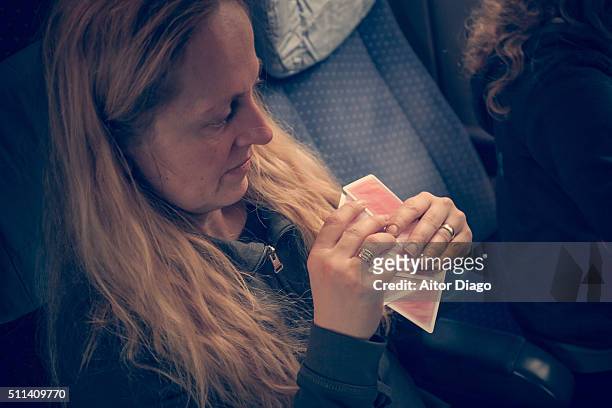 woman playing cards in a train. - passenger cabin stock pictures, royalty-free photos & images