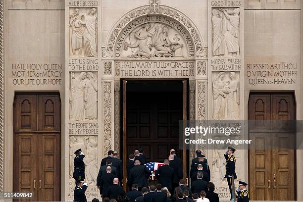 With family members following behind, pallbearers carry the casket of late Supreme Court Justice Antonin Scalia up the steps of the Basilica of the...