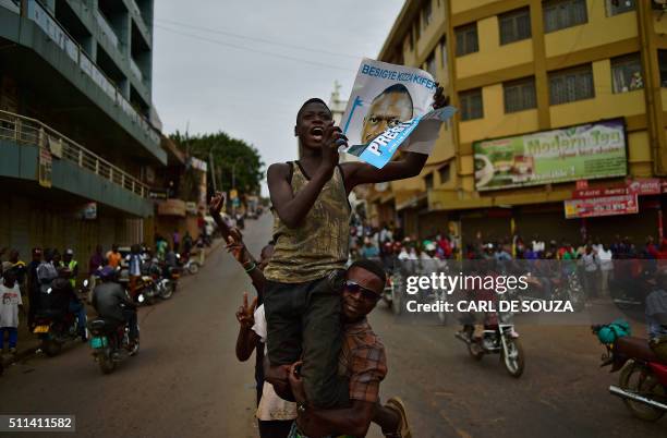 Supporters of opposition leader Kizza Besigye cheer for him despite the announcement that President Yoweri Museveni has won the presidential election...