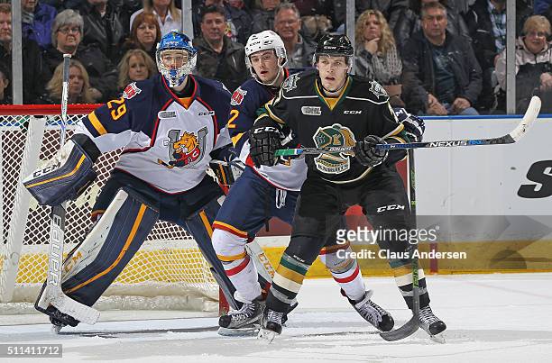 Mackenzie Blackwood of the Barrie Colts looks to face a shot while teammate Greg DiTomaso tries to contain Matthew Tkachuk of the London Knights...