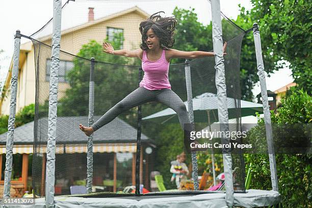 teenager girl jumping on trampoline outdoors - girls tights stock pictures, royalty-free photos & images