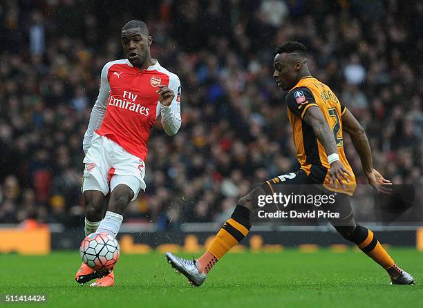 Joel Campbell of Arsenal passes the ball under pressure from Moses Odubajo of Hull during the match between Arsenal and Hull City in the FA Cup 5th...