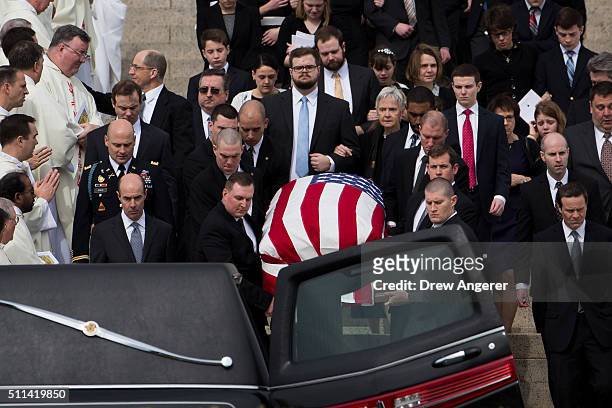 With family members following behind, pallbearers carry the casket of late Supreme Court justice Antonin Scalia down the steps of the Basilica of the...