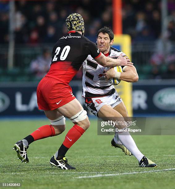 James Hook of Gloucester is tackled by Kelly Brown during the Aviva Premiership match between Saracens and Gloucester at Allianz Park on February 20,...