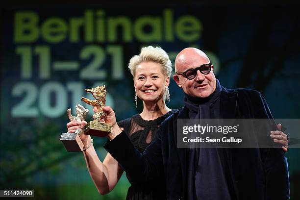 Actress Trine Dyrholm and director Gianfranco Rosi pose with their awards on stage during the closing ceremony of the 66th Berlinale International...