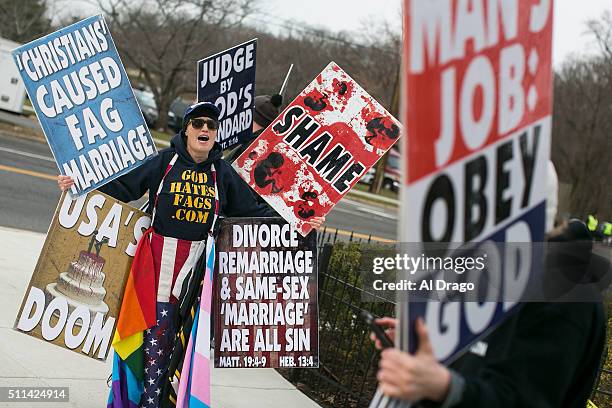 Members of the Westboro Baptist Church, based out of Topeka, Kansas, picket before the casket containing the body of the late Supreme Court Associate...