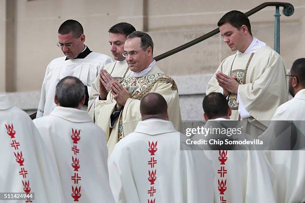 Rev. Paul Scalia , son of former U.S. Supreme Court Associate Justice Antonin Scalia, walks between rows of Catholic clergy as he leaves the Basilica...