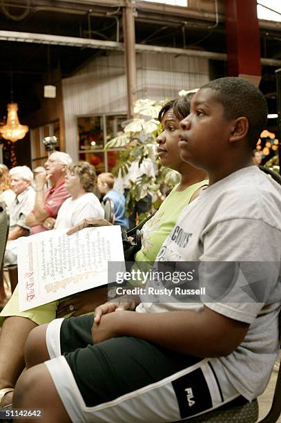Regina Holloway and her son, Christian Holloway listen during a rally celebrating the Ten Commandments August 4, 2004 in Franklin, Tennessee. The...