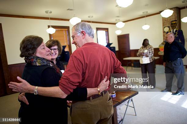 Voters and a poll station official embrace at the Denmark Depot polling precinct on February 20, 2016 in Denmark, South Carolina. Statewide voters...