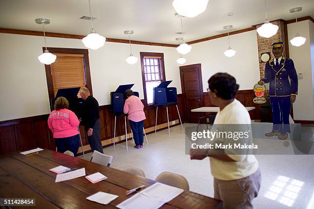 Poll official observes voters at the Denmark Depot polling precinct on February 20, 2016 in Denmark, South Carolina. Statewide voters will cast...