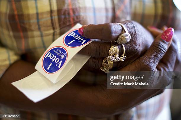 Poll station official holds "I Voted" stickers at the Denmark Depot polling precinct on February 20, 2016 in Denmark, South Carolina. Statewide...