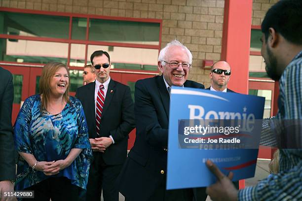 Democratic presidential candidate Sen. Bernie Sanders and his wife, Jane O'Meara Sanders, greet voters as they visit the Western High School caucus...