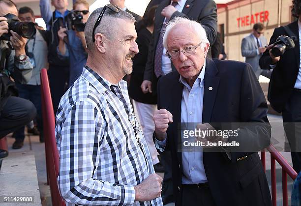 Democratic presidential candidate Sen. Bernie Sanders greets voters standing in line as he visits the Western High School caucus site on February 20,...